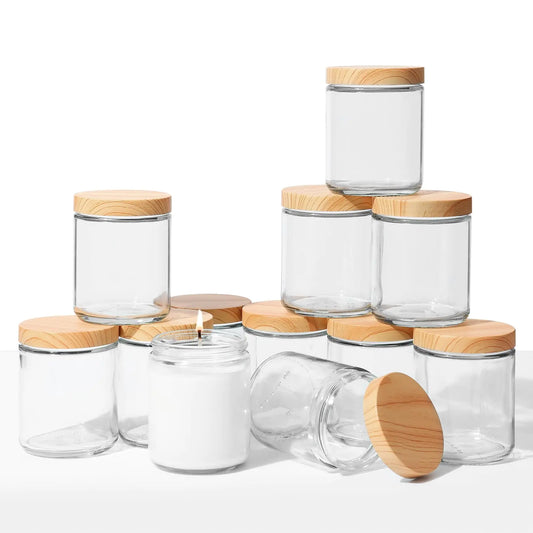 Set of clear glass jars with wooden lids on a white background