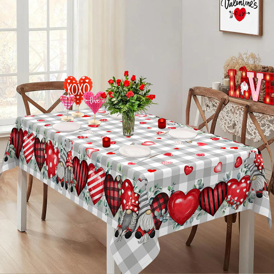 Dining table set with a Valentine's Day-themed tablecloth featuring hearts and gnomes.