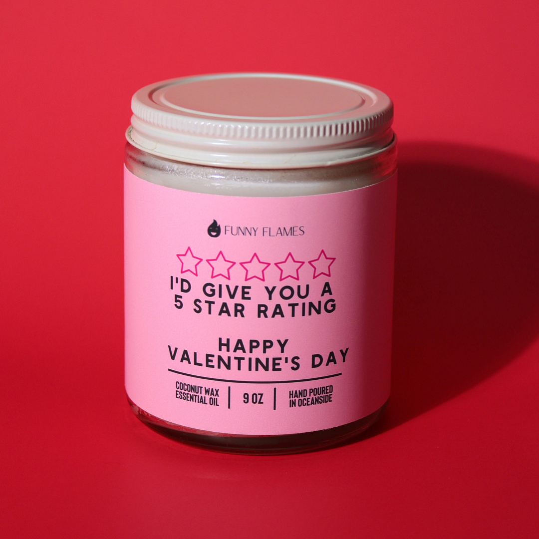 Pink candle jar with a humorous label on a red background